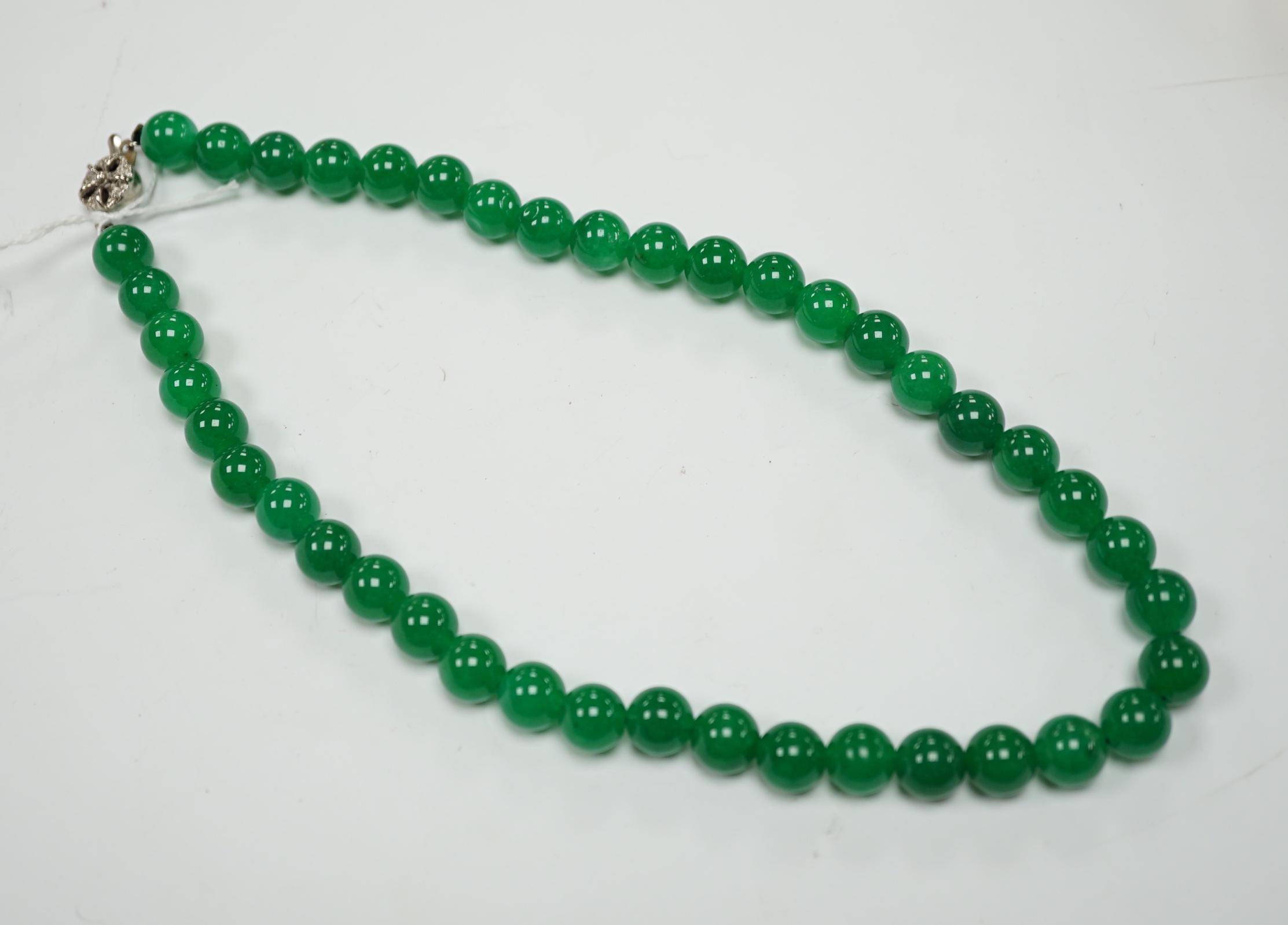 A single strand jade bead necklace, with white metal clasp, 42cm.